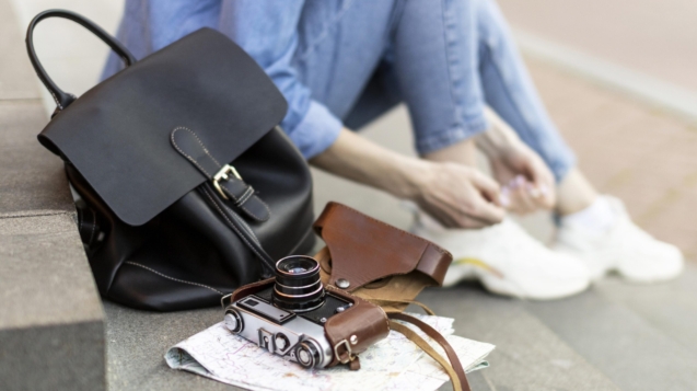 close-up-tourist-with-backpack-camera-scaled